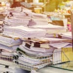 Pile of documents on desk stack up high
