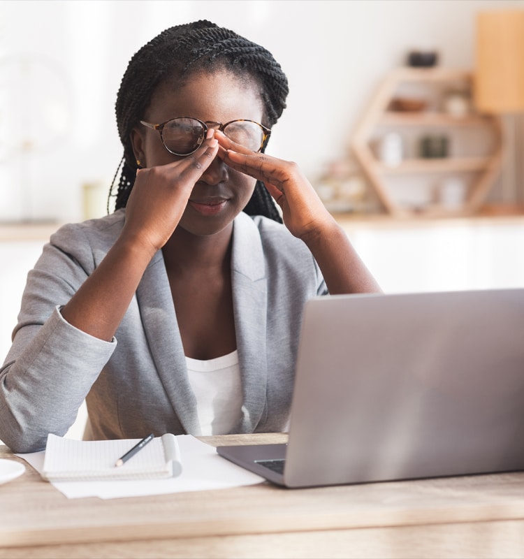 Overworked Black Businesswoman Massaging Nosebridge At Workplace Having Eyesight Problem